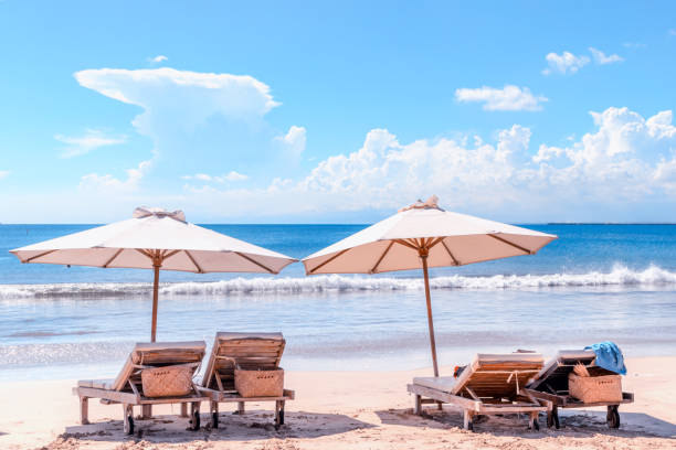 istock Beach with chairs. Sunbeds and umbrella at Bali coast. 1125728765
