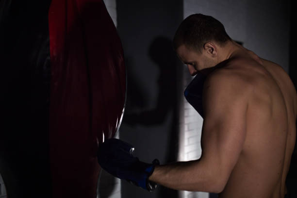 istock Man is boxing in gym 1125728862