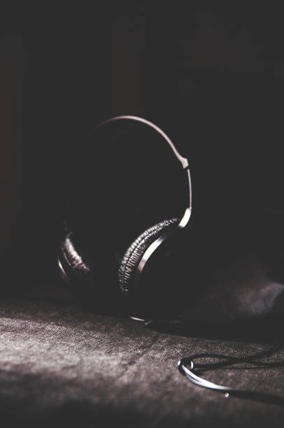 istock Black headphones on a dark background. Space for design or text 1125729580