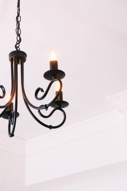 istock Black chandelier in white interior 1125729647
