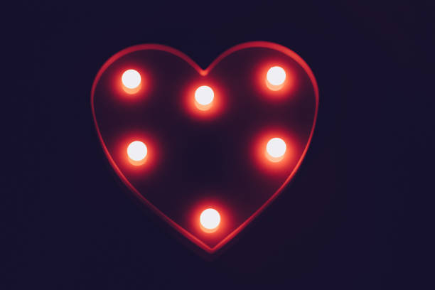 Glowing red heart with flashlights closeup.