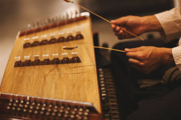 istock Young musician playing traditional dulcimer instrument 1125730425