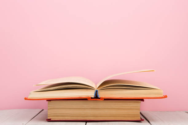 istock education and wisdom concept - open book on wooden table, color background 1125731490