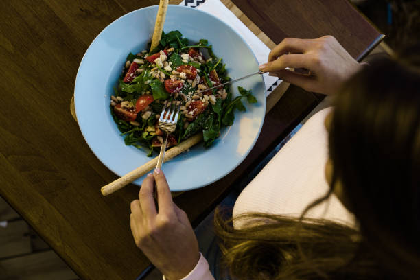 istock Woman having food at restaurant table 1125734222