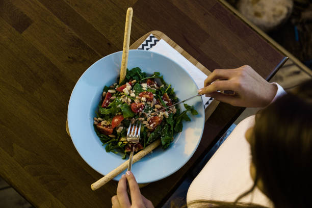 istock Woman having food at restaurant table 1125736565