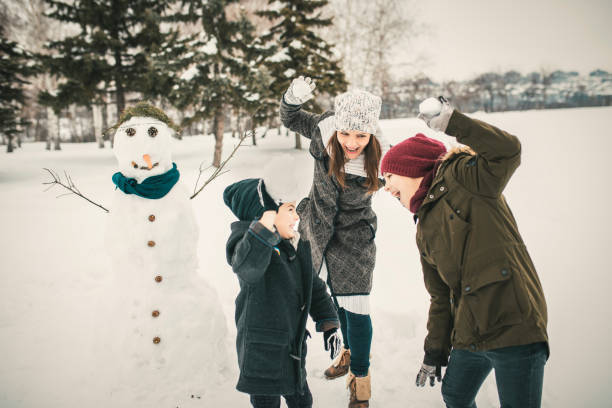istock Kids Playing with Mum In Snow, Snowballing 1125737285