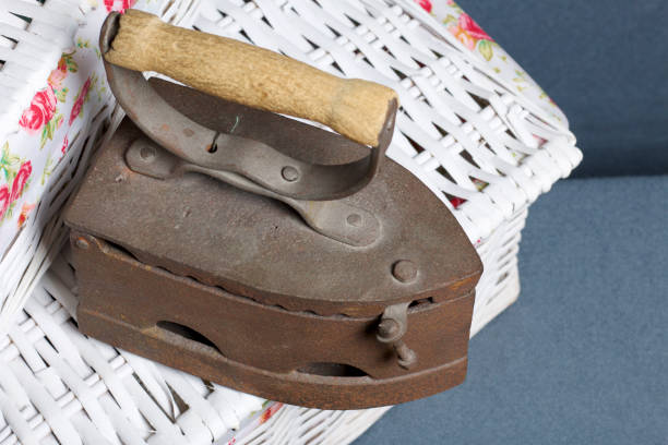 Old iron, heated by hot coals. Located on a wicker baskets.