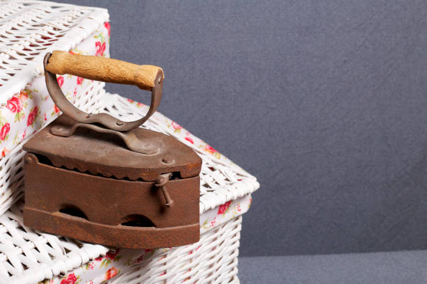 istock Old iron, heated by hot coals. Located on a wicker baskets. 1125739110