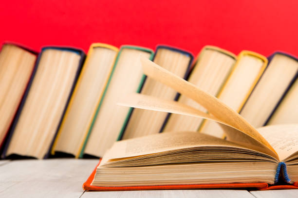 istock education and wisdom concept - open book on wooden table, color background 1125739358