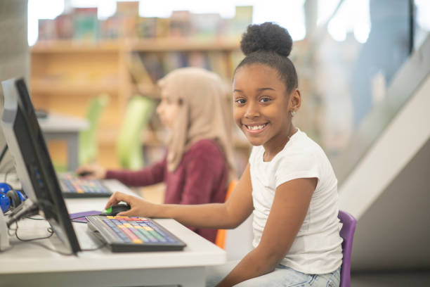 istock Smiling girl sitting at her computer 1125739938
