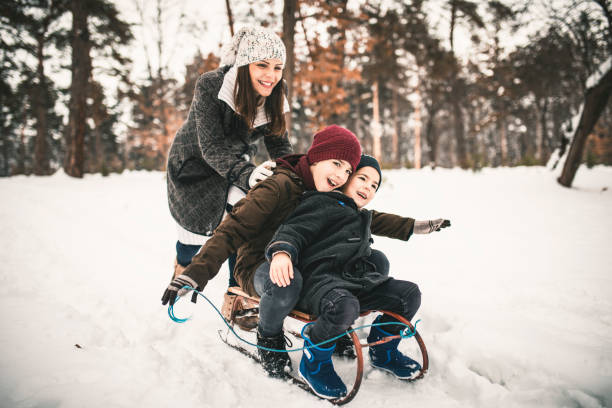 istock Boys and Mum On A Sled Playing In The Snow 1125741495