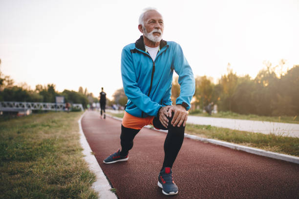 istock Senior athlete stretching on a running track 1125741578