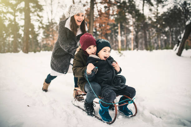 istock Boys and Mum On A Sled Playing In The Snow 1125743039