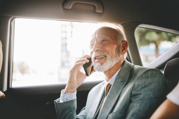 istock Cheerful senior businessman smiling while taking on a mobile phone 1125746282