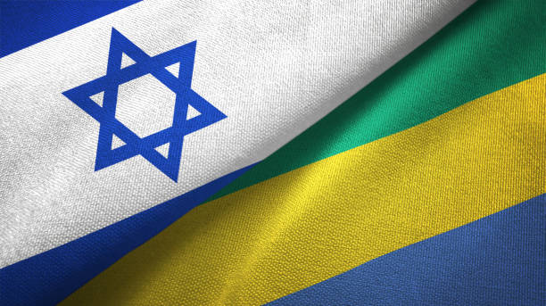 istock Gabon and Israel two flags together textile cloth, fabric texture 1125756716