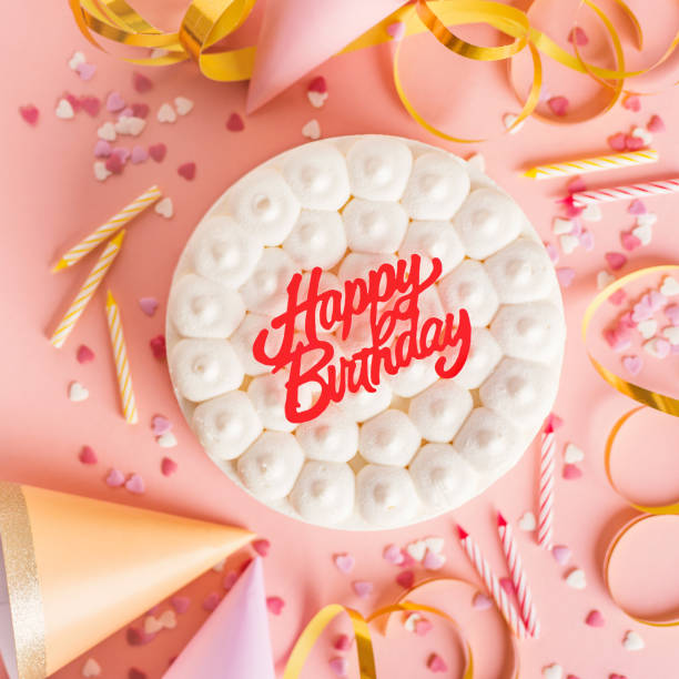 Happy colorful birthday party background with birthday cake and party accessorizes. Top View with copy space. Pink Background. Square.