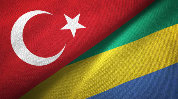 istock Gabon and Turkey two flags together textile cloth, fabric texture 1125757334