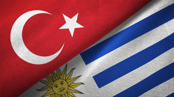 istock Uruguay and Turkey two flags together textile cloth, fabric texture 1125757975