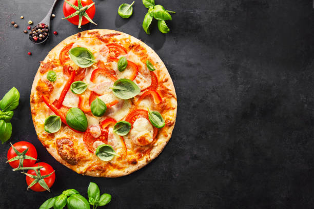 istock Tasty vegetarian pizza on dark background 1125758344
