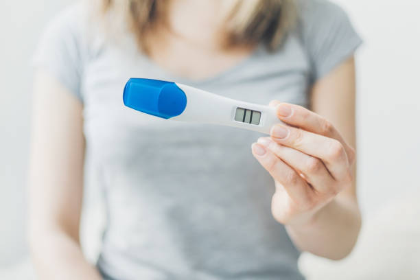 istock Woman shows positive pregancy test 1125758466