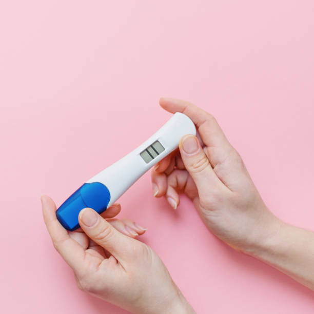 istock Woman shows positive pregancy test 1125758471