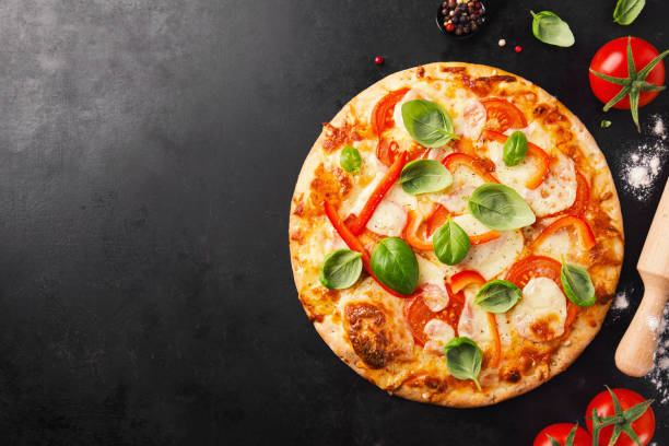 istock Tasty vegetarian pizza on dark background 1125758506