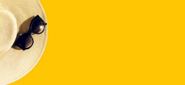 istock Straw hat with sunglasses on yellow 1125758759