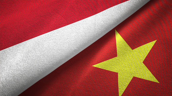 Vietnam and Indonesia flags together textile cloth, fabric texture