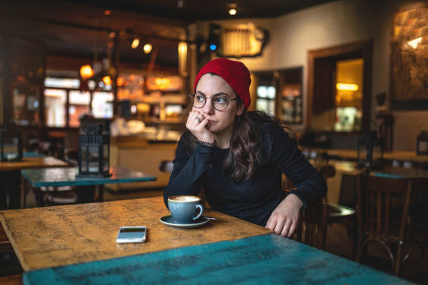 istock Contemplating girl spending time at a coffee shop 1125759577