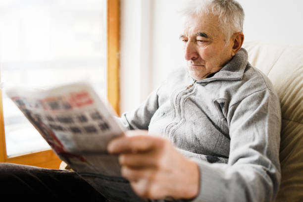 istock Senior Man Reading Papers At Nursing Home 1125761813