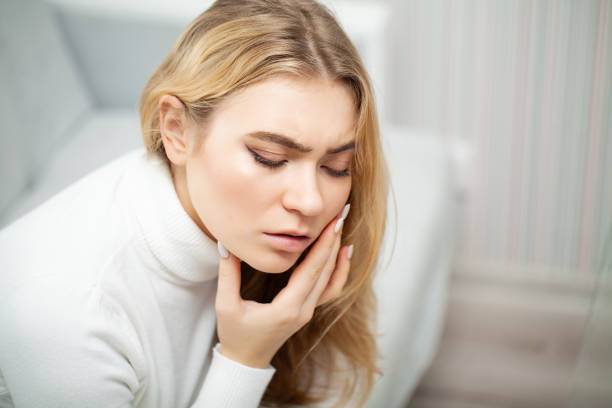 istock Tired woman keeping hand on her head 1125761922