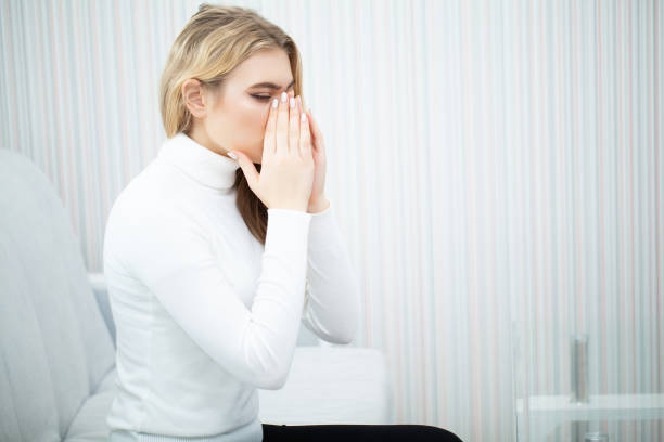 istock Tired woman keeping hand on her head 1125761943
