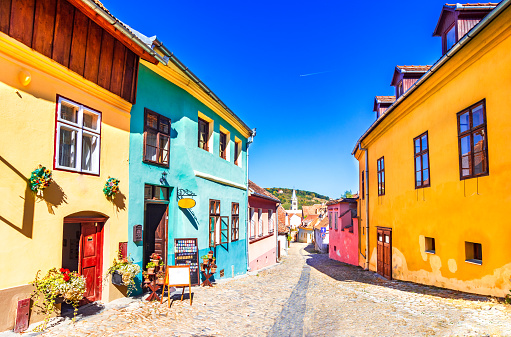 Sighisoara, Romania: Famous stone paved old streets with colorful houses in the medieval city-fortress Sighisoara,Transylvania, Europe