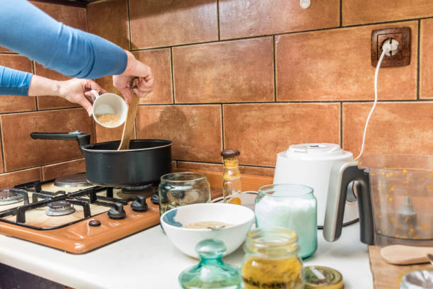 istock Woman in Domestic Kitchen Making Pumpkin Risotto 1125769566