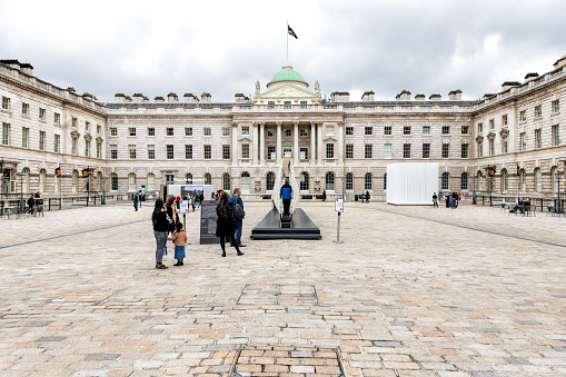 London, UK - September 12, 2018: Somerset House historical neoclassical building with flag and large square wide angle view and people