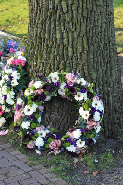 White and purple sympathy flowers in a funeral wreath