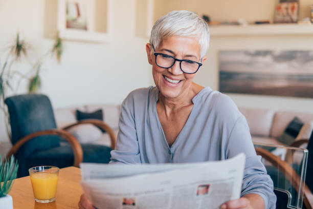 istock Woman looking at newspaper 1125774024