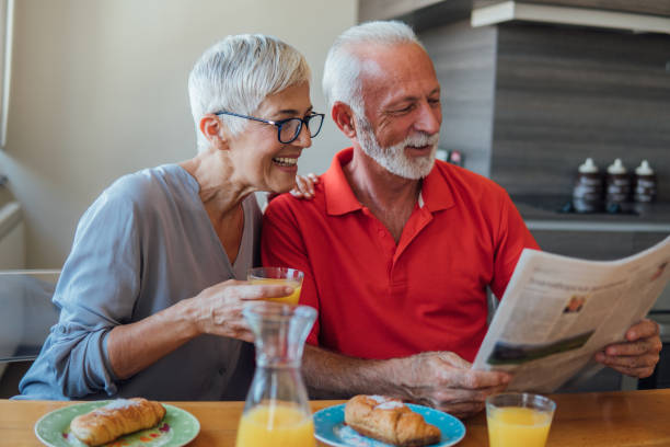 istock Senior couple reading newspapers together 1125775796