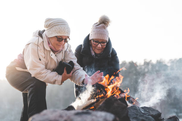 istock Two senior women by a campfire in winter 1125777182