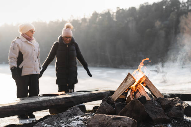 istock Two senior women by a campfire in winter 1125777186