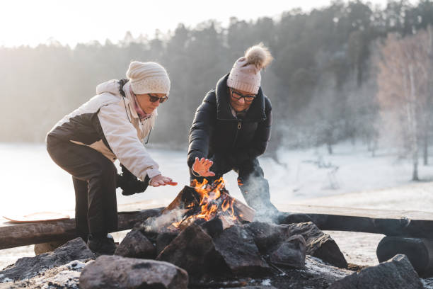 istock Two senior women by a campfire in winter 1125777189