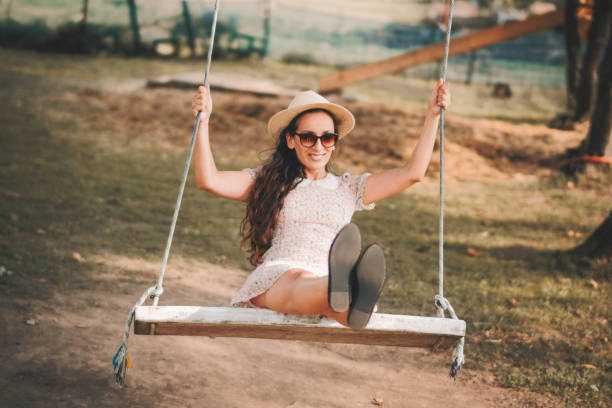 istock Happy young woman having fun on the swing 1125778437