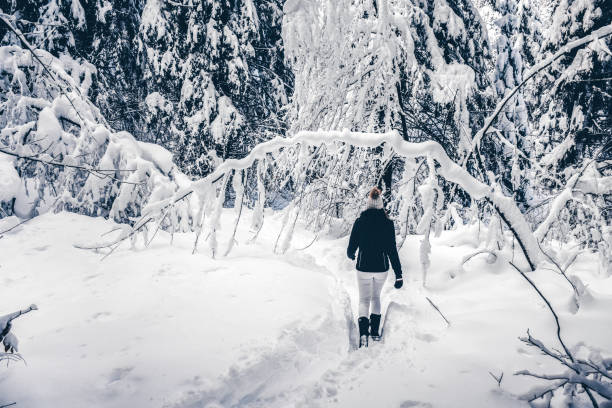 istock Young woman enjoying hiking in deep snow 1125780661