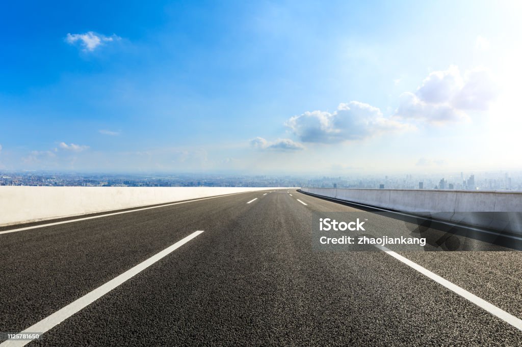 Empty asphalt road and modern city skyline with buildings in Shanghai Empty asphalt road and modern city skyline with buildings in Shanghai,China Multiple Lane Highway Stock Photo