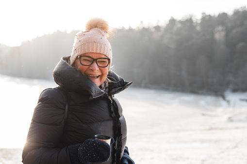 Active seniors on a walk through the beautiful Swedish landscapes in winter.