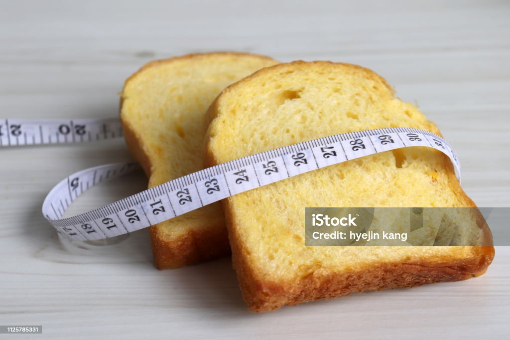 Bread and a tape line. Carbohydrate - Food Type Stock Photo