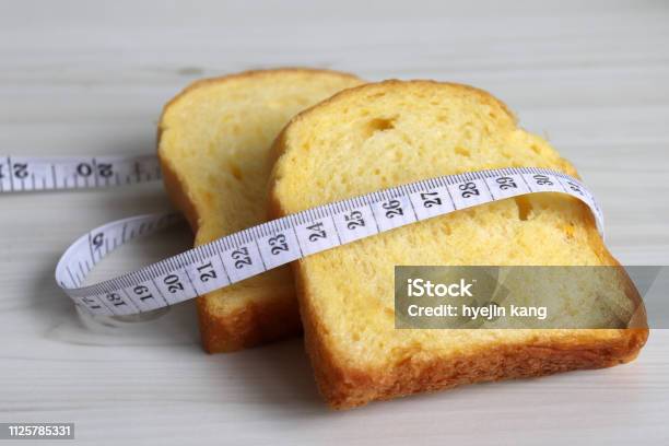 Bread And A Tape Line Stock Photo - Download Image Now - Carbohydrate - Food Type, Reduction, Care