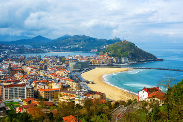 San Sebastian - Donostia city, Basque country, Spain San Sebastian - Donostia city, Basque country, Spain, view of the Zurriola beach, Urgull mount, La Concha bay, surrounding Pyrenees mountains and Atlantic ocean espana stock pictures, royalty-free photos & images