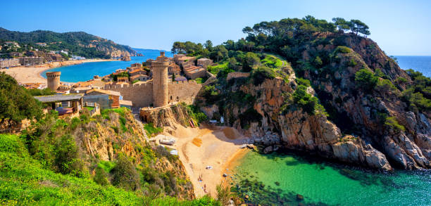 Tossa de Mar, sand beach and Old Town walls, Catalonia, Spain Tossa de Mar, the historical Old Town walls and sand beach on Costa Brava mediterranean coast, Catalonia, Spain tossa de mar stock pictures, royalty-free photos & images