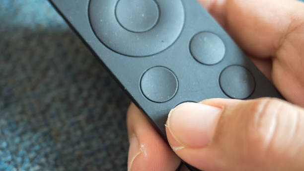 istock Man press with his finger on remote close up 1125791917